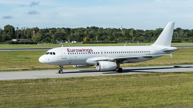 A Eurowings airplane taxiing on the runway at Hamburg Airport, Germany.