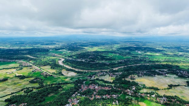 Stunning aerial view of Serang, Banten, showcasing lush greenery, river, and farmland.